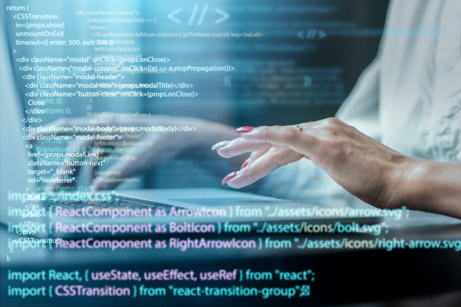 Hands typing on a laptop keyboard with overlayed code snippets, representing Node.js development and modern JavaScript programming.